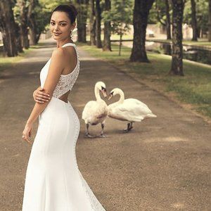 Sheer back crepe wedding dress with lace train